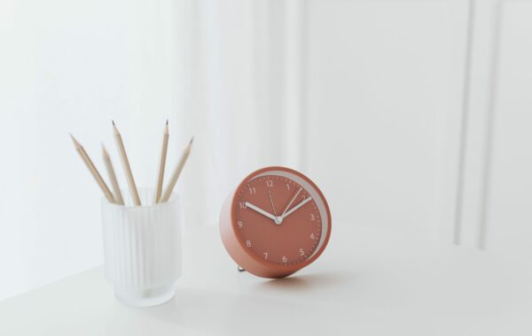 Small pink clock on desk